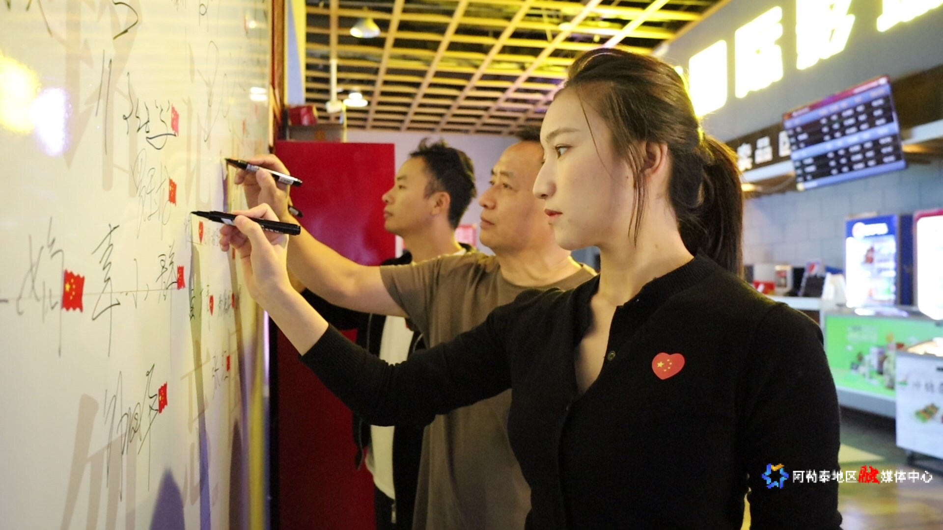 在雪影国际影城内，观看电影《731》的观众们正在专门设立的观影心声墙上签名。2